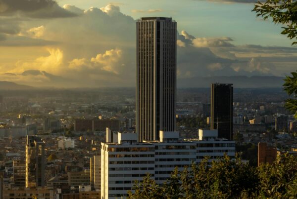 Skyscraper against a dramatic sky in a vibrant cityscape, ideal for urban stock photography.